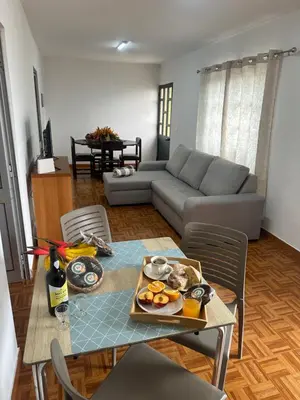 a living room with a table and a couch at Casa Rosa in Ribeira Brava