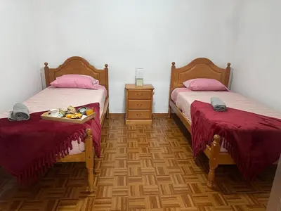 a room with two beds and a tray of food on a tray at Casa Rosa in Ribeira Brava