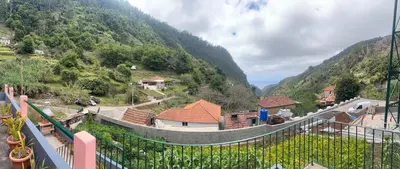 a pink house with a car parked in front of it at Casa Rosa in Ribeira Brava