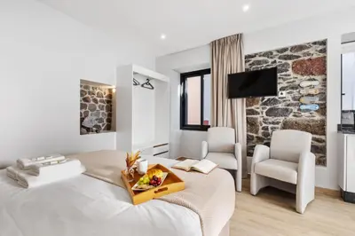 a hotel room with a bed with a tray of food on it at Seaside Sunset by Homie in Paul do Mar