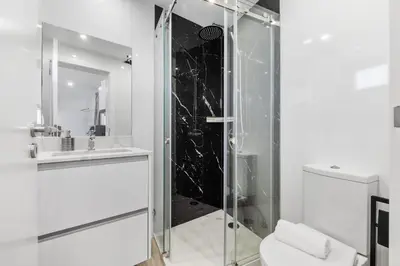 a bathroom with a shower and a toilet and a sink at Seaside Sunset by Homie in Paul do Mar