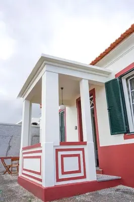 a red and white house with green shutters at Renovated Traditional House w 3BR & Outdoor Space in Funchal