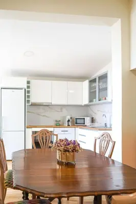 a kitchen with a wooden table with flowers on it at Renovated Traditional House w 3BR & Outdoor Space in Funchal