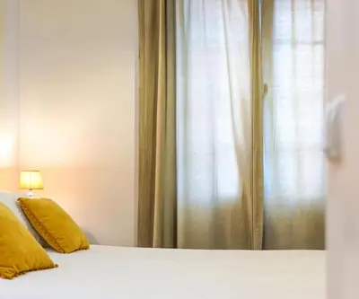 a bedroom with a bed with yellow pillows and a window at Renovated Traditional House w 3BR & Outdoor Space in Funchal