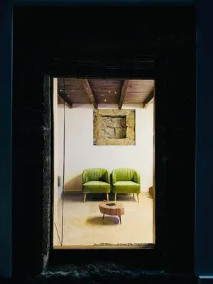 a room with a green couch and a table at Villas Calhau da Lapa 10 in Campanário