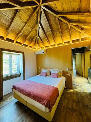 a bedroom with a large bed with a wooden ceiling at Villas Calhau da Lapa 10 in Campanário