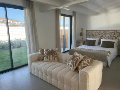a living room with a couch and a bed and a bedroom at Casa Zavial in Carrapateira