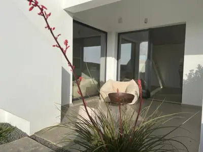 a living room with a couch and a plant at Casa Zavial in Carrapateira
