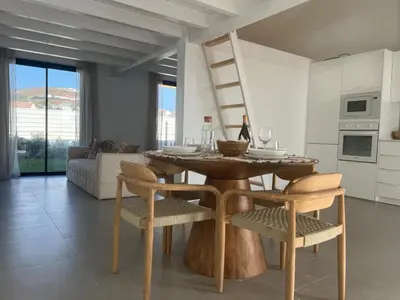 a living room with a wooden table and chairs at Casa Zavial in Carrapateira