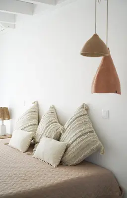 a bedroom with a bed with pillows on it at Casa Barranco in Carrapateira