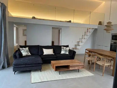 a living room with a couch and a table at Casa Furnas in Carrapateira