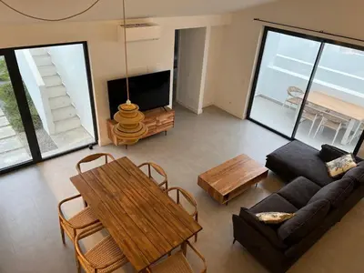 a living room with a couch and a table at Casa Furnas in Carrapateira