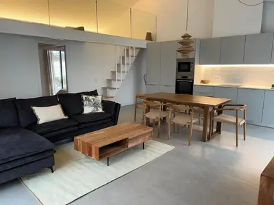 a living room with a couch and a table at Casa Furnas in Carrapateira