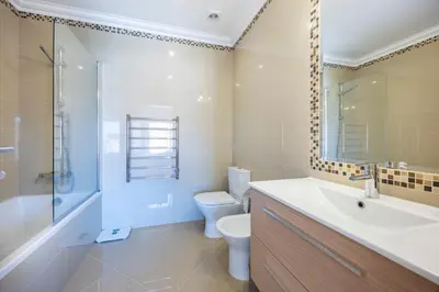 a bathroom with a toilet and a sink and a shower at Boa Vista - Casa Jacques in Lagos