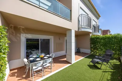 a patio with a table and chairs in front of a house at Boa Vista - Casa Jacques in Lagos
