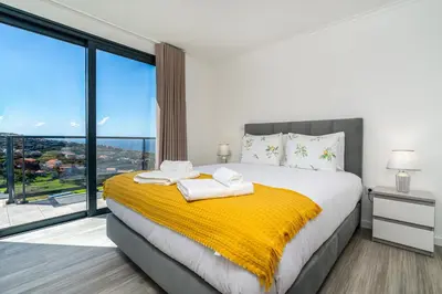 a bedroom with a large bed with a yellow blanket at Casa Antonette, Lovely house with a pool in Calheta