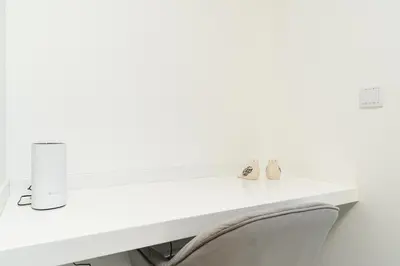 a white desk with a chair in a room at Casa Antonette, Lovely house with a pool in Calheta