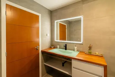 a bathroom with a sink and a mirror at Casa Antonette, Lovely house with a pool in Calheta