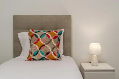 a bedroom with a bed with a pillow and a lamp at Casa Antonette, Lovely house with a pool in Calheta