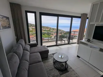 a living room with a couch and a television at Apartment Antonette in Calheta