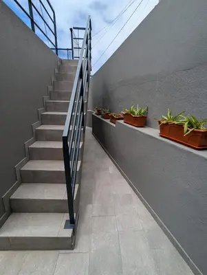 a staircase with potted plants on the side of a building at Apartment Antonette in Calheta
