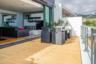a living room and dining area of a house at Casa Refúgio dos Canhas in Ponta do Sol