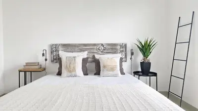 a bedroom with a white bed with pillows at Casa do Pico by Casas dos Lebre in Porto Santo