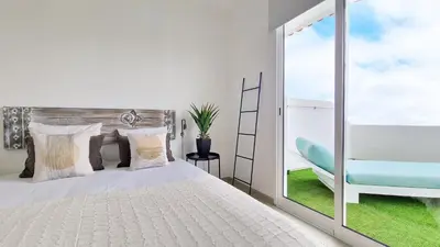 a bedroom with a bed and a sliding glass door at Casa do Pico by Casas dos Lebre in Porto Santo