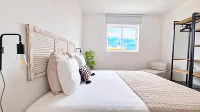 a bedroom with a large bed with white pillows at Casa do Pico by Casas dos Lebre in Porto Santo
