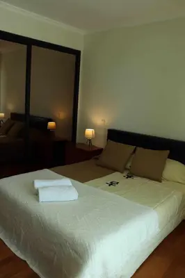 a bedroom with a large bed with two towels on it at GuestReady - Rodamar Apartment in Funchal