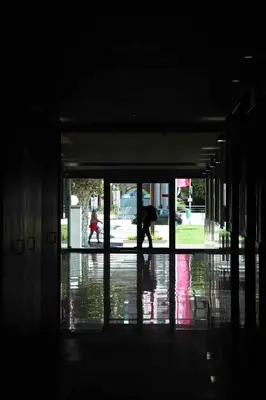 a person walking in the rain with an umbrella at GuestReady - Rodamar Apartment in Funchal