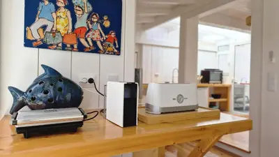 a desk with a computer and a printer on it at Nossa Casa by Casas dos Lebre in Porto Santo