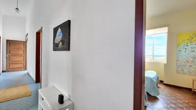 a room with white walls and a bedroom with a bed at Casa da Ponta by Casas dos Lebre in Porto Santo
