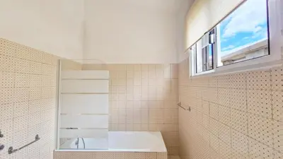 a bathroom with a bath tub and a window at Casa da Ponta by Casas dos Lebre in Porto Santo