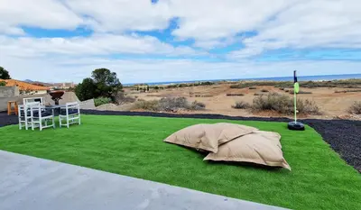 a green lawn with a table and a tent on it at Casa da Ponta by Casas dos Lebre in Porto Santo
