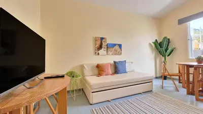 a living room with a couch and a flat screen tv at Casa da Ponta by Casas dos Lebre in Porto Santo