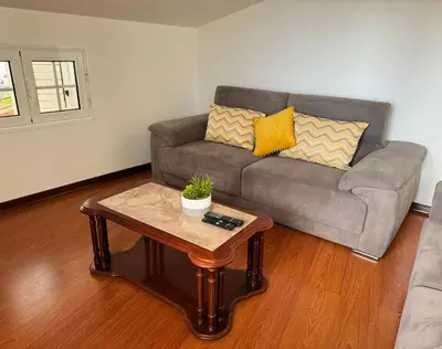 a living room with a couch and a coffee table at Arco Apartment in Arco da Calheta