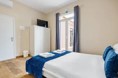 a bedroom with a large bed with a window at A ver o mar rooms - Santa Cruz city center in Santa Cruz