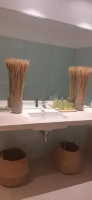 a bathroom with a sink and some straw baskets at Funchal Next Corner in Funchal