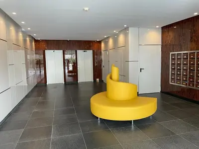 a yellow chair in a room with some doors at Funchal Next Corner in Funchal