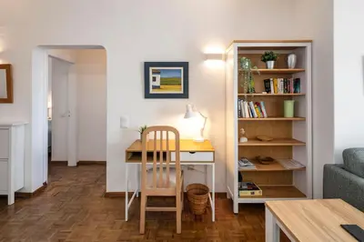 a bedroom with a blue bed and a balcony at Seascape - Escape to the seaside in Luz