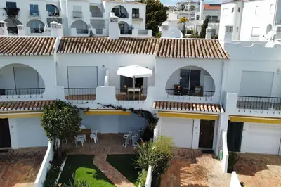 a bedroom with a bed and a desk and a window at Seascape - Escape to the seaside in Luz