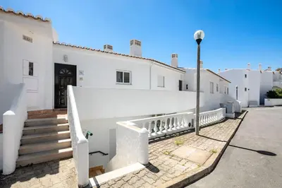 a view of a beach with a building and the ocean at Seascape - Escape to the seaside in Luz