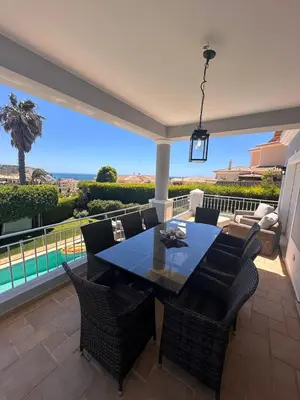 a dining room with a table and chairs on a patio at 3 Bedroom villa with a sea view completely private in Alagoas