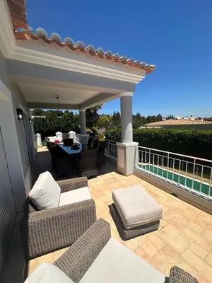 a patio with couches and a table on a balcony at 3 Bedroom villa with a sea view completely private in Alagoas