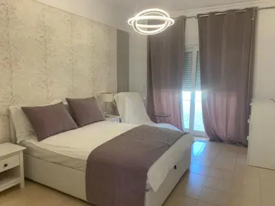a bedroom with a large bed and a chandelier at 3 Bedroom villa with a sea view completely private in Alagoas