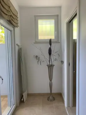 a vase with a flower in the corner of a room at 3 Bedroom villa with a sea view completely private in Alagoas
