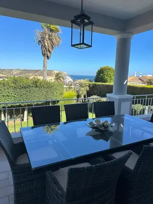 a dining table and chairs on a patio at 3 Bedroom villa with a sea view completely private in Alagoas