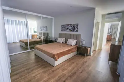 a bedroom with two beds and a large mirror at Casa do Beco do Barlavento in Vila Baleira