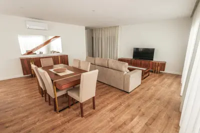 a living room with a table and a couch at Casa do Beco do Barlavento in Vila Baleira
